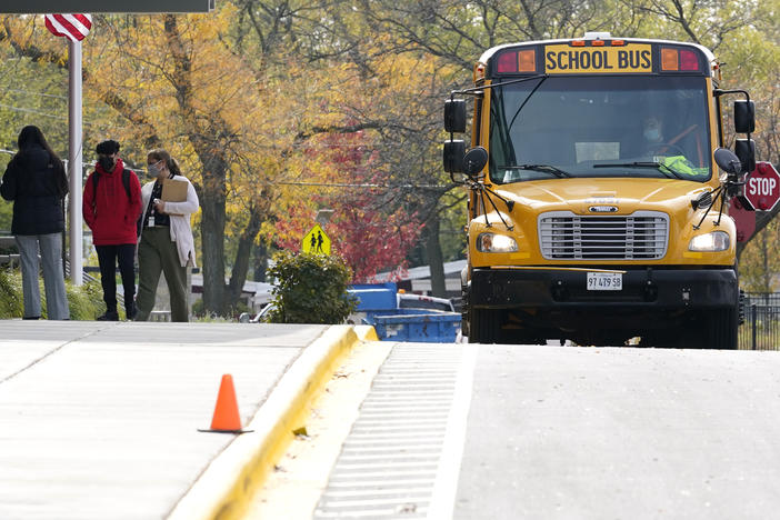 Students wear mask as they arrive at school for in-person learning at Holmes Middle School in Wheeling, Ill., on Oct. 21, 2020. Students in Illinois schools will be able to take up to five excused mental or behavioral health days beginning in January 2022.