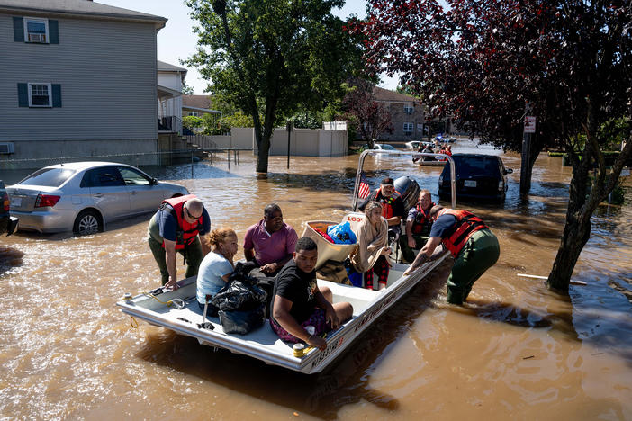 Members of the fire department in Lodi, N.J., perform water rescues Thursday on residents trapped after torrential rains from the remnants of Hurricane Ida.
