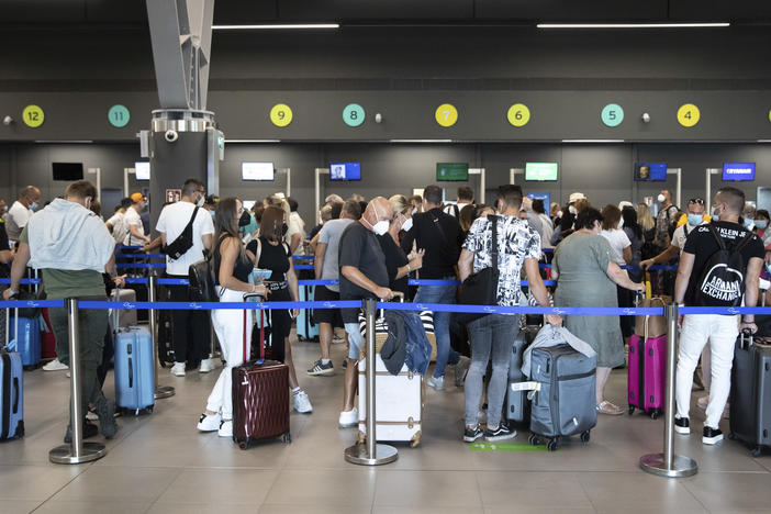 Passengers queue up at Greece's Thessaloniki Makedonia Airport on Sept. 2. Recommendations about physical distancing prove hard to follow at airports — and in the jetway leading to the plane.