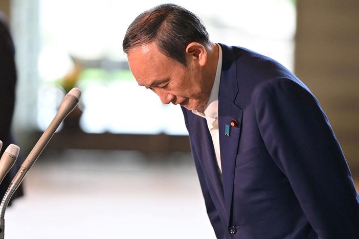 Japan's Prime Minister Yoshihide Suga bows during a press conference at the prime minister's office in Tokyo on Friday, following his announcement that he will not seek reelection for Liberal Democratic Party leadership this month.