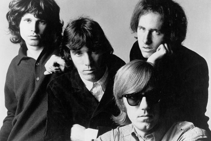 The members of The Doors, from left to right: Jim Morrison, John Densmore, Robby Krieger and Ray Manzarek (seated).