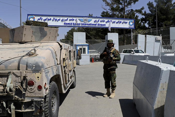 A Taliban soldier stands guard at the gate of Hamid Karzai International Airport in Kabul, Afghanistan, on Sunday.
