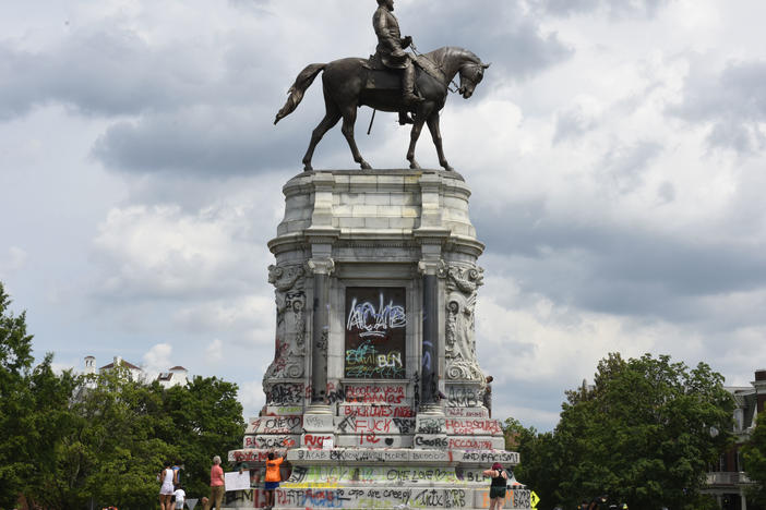 Protesters climb on the base of the statue of Confederate General Robert E. Lee on Monument Avenue on June 6, 2020 in Richmond, Virginia amid continued protests over the death of George Floyd in police custody. The statue is set to be taken down on Sept. 8, 2021.