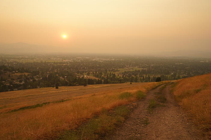 Wildfire smoke blankets Missoula, Mont., at the end of a hot summer day. The mountain town has been inundated with smoke for weeks this summer.