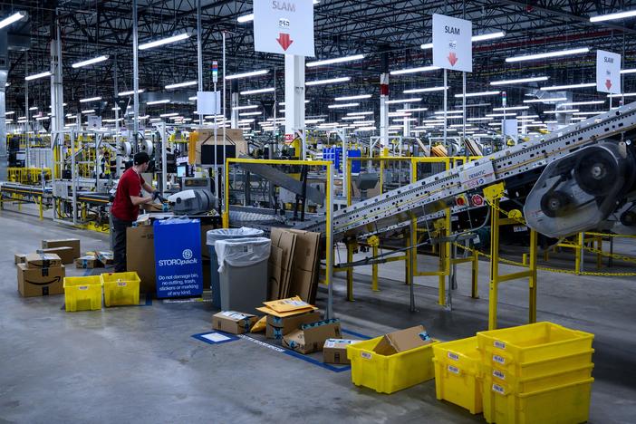 A man works at a conveyor belt at an Amazon warehouse in New York City in 2019.