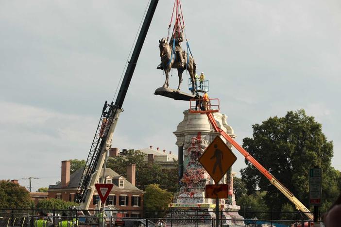 The statue of Confederate Gen. Robert E. Lee is removed from its pedestal Wednesday in Richmond, Va.