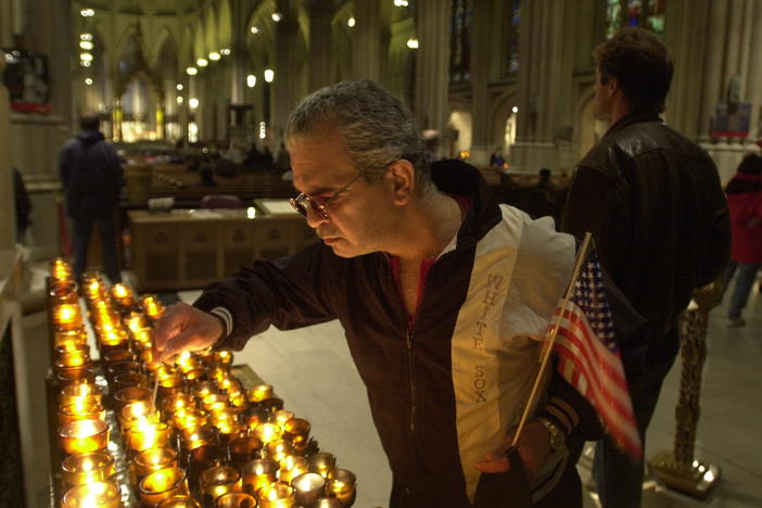 A man in New York City lights a candle on Sept. 14, 2001, for the victims of the Sept. 11 terrorist attacks.