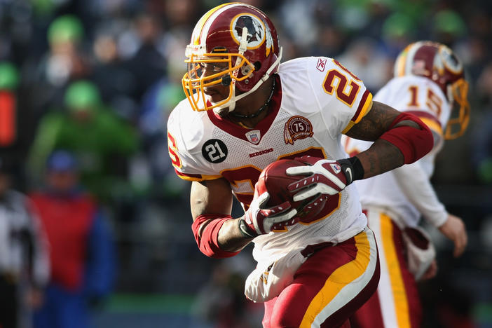 Former Washington Football Team running back Clinton Portis carries the ball during an NFL wildcard playoff football game against the Seattle Seahawks in Jan. 2008. Portis plead guilty to health care fraud charges Tuesday, authorities said.