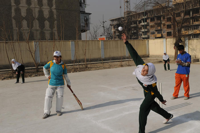 Afghan girls play cricket on school grounds in Kabul in 2010. At the time, Afghanistan was set to select its first national women's cricket team. But a Taliban official now reportedly says women won't be allowed to play it and other sports.