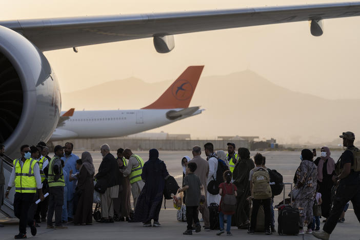 Passengers board a Qatar Airways aircraft at the airport in Kabul, Afghanistan on Thursday.