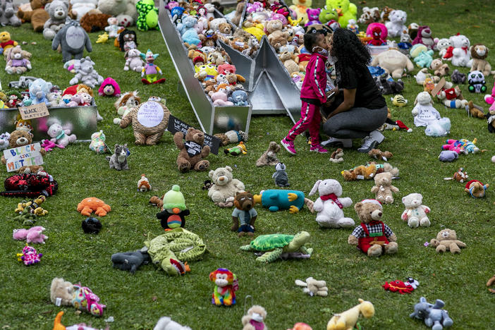 A young girl and her mother visit a temporary art installation, called Bear the Truth, on June 28, 2020, at the Los Angeles City Hall. The installation honors Black children who have lost their lives to racial injustice and senseless violence.