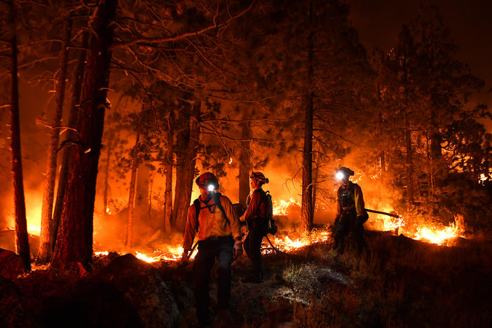 Firefighters battle the Caldor Fire this month along Highway 89 west of Lake Tahoe in California.