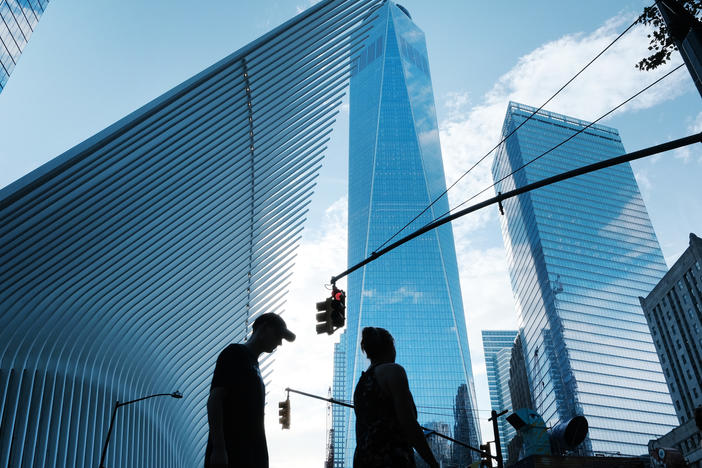 People walk near the sight of Ground Zero and the One World Trade Center on Aug. 30. The Wall Street neighborhood changed drastically after the 9/11 attacks as banks moved out of what had long been their home.