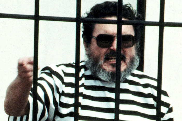 In this Sept. 1992 file photo, Abimael Guzmán, the founder and leader of the Shining Path guerrilla movement, shouts inside of a jail cell after being captured in Lima, Peru. The Peruvian government reported Saturday that Guzman died after an illness.