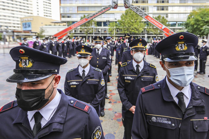 Members of the Berlin city fire department attend a ceremony Saturday near the Breitscheidplatz memorial to commemorate fellow firefighters and other victims killed in the 9/11 terror attacks in New York City.