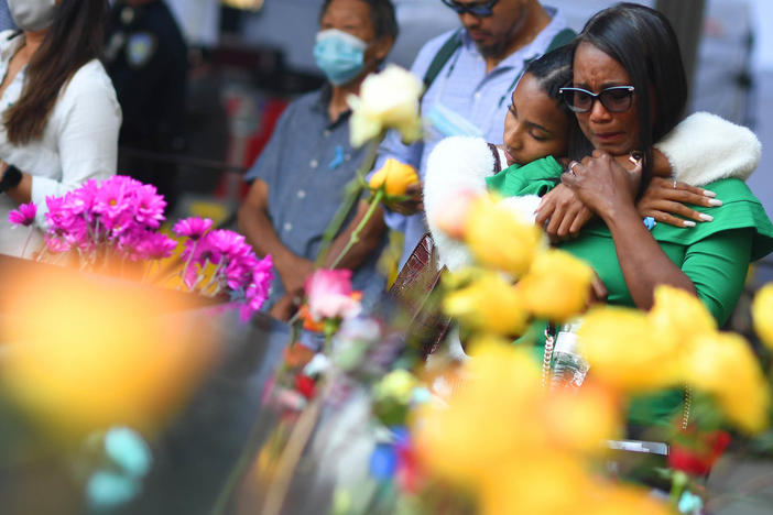 Danielle Booker hugs her mother, Sharon Booker, as the two remember Sean Booker, Danielle's father and Sharon's husband, at the National September 11 Memorial & Museum during a ceremony on Saturday in Manhattan. Sean Booker was a technician on the 93rd floor of the World Trade Center's north tower when he was killed during the 2001 attacks.
