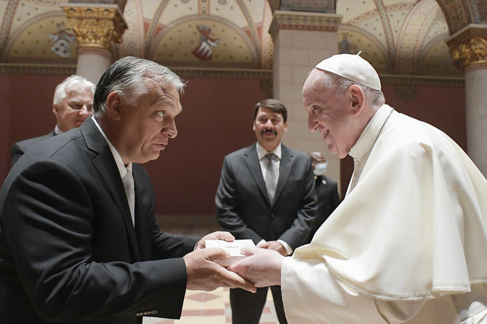 Pope Francis exchanges gifts with Hungarian Prime Minister Viktor Orban, at Budapest's Museum of Fine Arts on Sunday. Francis is opening his first foreign trip since undergoing major intestinal surgery in July, embarking on a four-day, two-nation trip to Hungary and Slovakia.