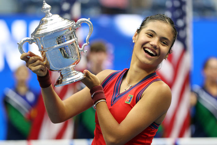Emma Raducanu of Great Britain celebrates with the championship trophy after defeating Leylah Annie Fernandez of Canada during their women's singles final match on Day 13 of the 2021 US Open on Saturday.
