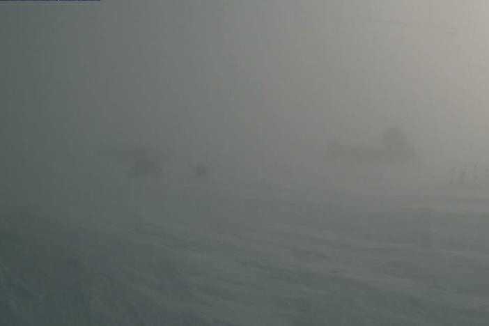 A webcam still showing blizzard conditions at Summit Station, a weather research station at Greenland's highest point. In August, the station recorded rain for the first time ever.