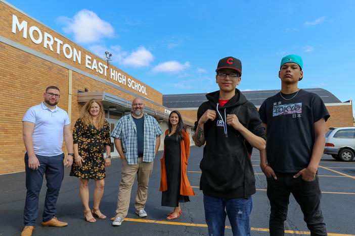 <strong>From left to right:</strong> Teachers Mark Sujak, Sarah Lorraine, Jeremy Robinson and Sophia Faridi pose with students and podcast finalists Julian Fausto and Eric Guadarrama for portraits in front of Morton East High School, in Cicero, Ill.
