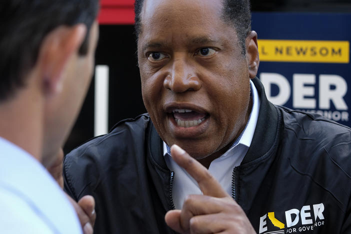 Republican conservative radio show host Larry Elder argues with a TV reporter in an interview Monday after visiting Philippe the Original deli during the campaign for the California gubernatorial recall election in Los Angeles.
