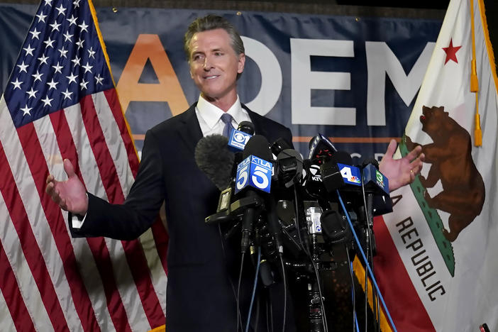 California Gov. Gavin Newsom addresses reporters Tuesday at the John L. Burton California Democratic Party headquarters in Sacramento after beating back the recall attempt that aimed to remove him from office.
