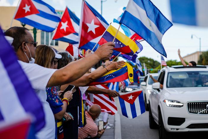 People hold Cuban, Venezuelan and Nicaraguan flags during a protest showing support for Cubans demonstrating against their government in Miami on July 18. The US. Latino population has grown significantly in the last decade.