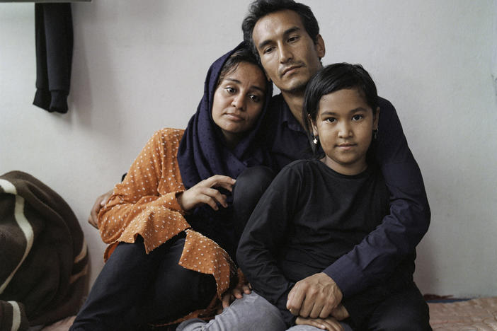 Sayyid Ali Hussaini (center), his wife Mahbube and daughter Elisa sit together in the Turkish city of Trabzon. Originally from the northern Afghan city of Mazar-e-Sharif, the family fled Taliban advances over the summer and arrived in Turkey last month.