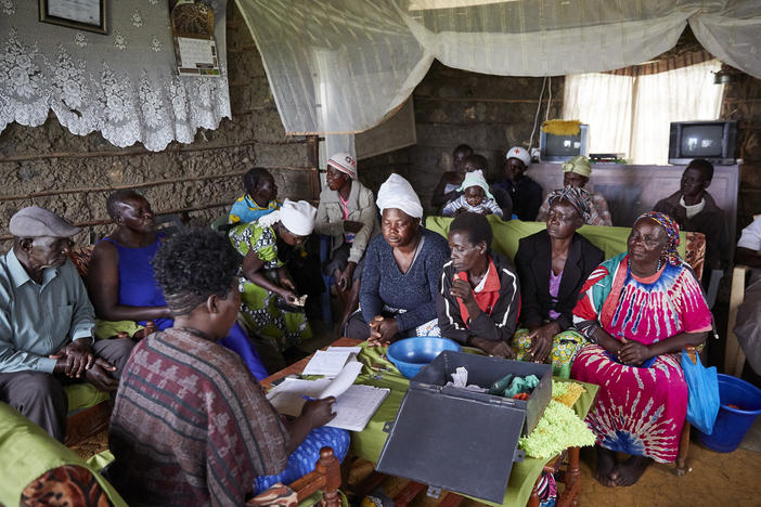 A meeting of the table banking group at the home of a member. The photo is from 2019, when No Sex for Fish (and the village) were thriving.