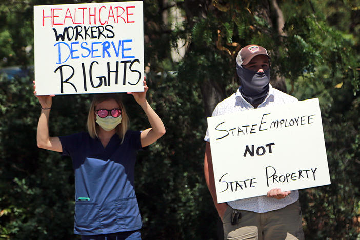 Nurse Katrina Philpot (left) protests against COVID-19 vaccine and mask mandates in Santa Fe, N.M., in August.