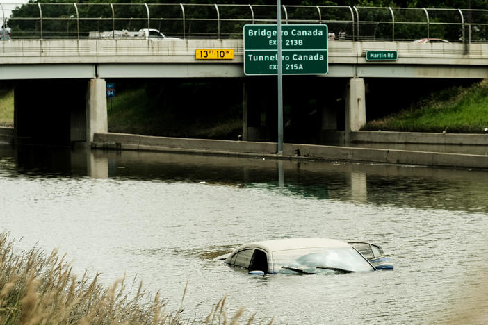 A car is submerged by floodwaters on a portion of I-94 in Detroit, several days after heavy rains flooded parts of the city in June.