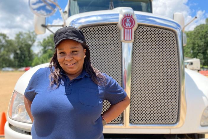 Pamela Williams, a driving instructor with DSC Training Academy, stands in front of one of the academy's trucks on June 29. Williams has been driving for seven years and enjoys seeing the country from the road.