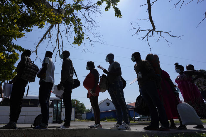 Migrants stand in line at a respite center in June after they crossed the U.S.-Mexico border and turned themselves in and were released in Del Rio, Texas.