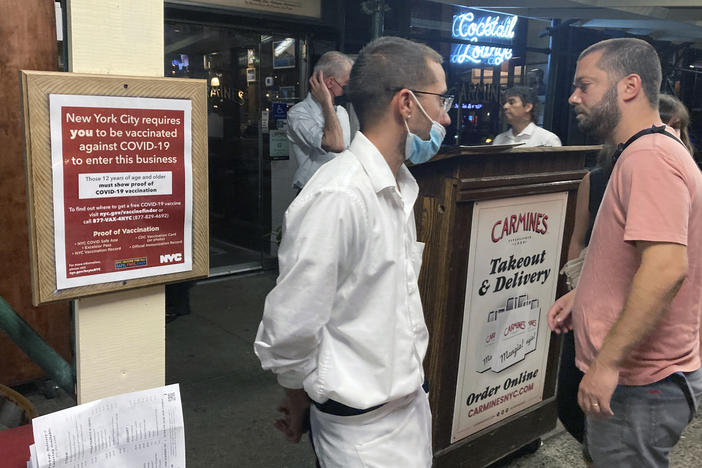 A sign in August informs customers that they must show proof of vaccination against COVID-19 in order to dine indoors at Carmine's Italian restaurant in Manhattan.