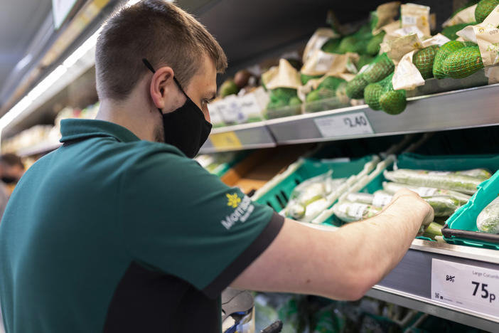 A staff member sorts through fresh produce at British supermarket chain Morrisons last month in Leeds, United Kingdom.