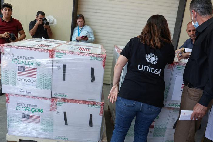 Palestinian Health Ministry staff members in Nablus receive 300,000 doses of COVID-19 vaccines donated by the United States through through the COVAX vaccine-sharing initiative on Aug. 24, 2021.