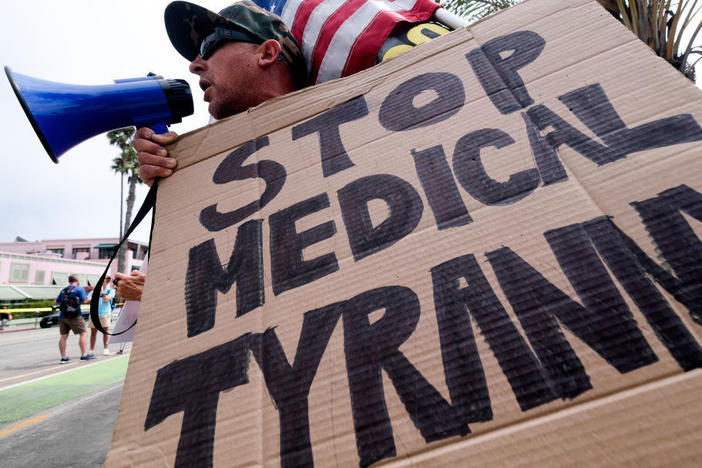 People opposed to COVID-19 vaccines often embrace ivermectin, a drug they think is not getting the attention it deserves. Here, an anti-vaccination protester takes part in a rally against vaccine mandates last month in Santa Monica, Calif.