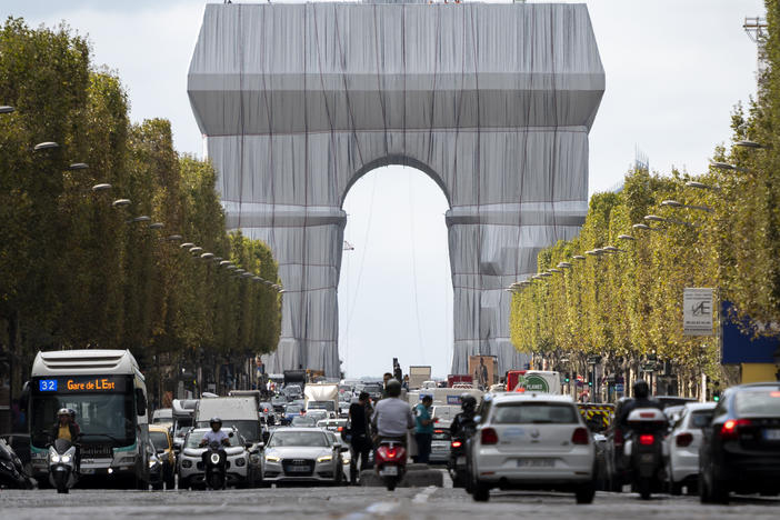The Arc de Triomphe in Paris is seen wrapped in fabric, in a posthumous art project that is an homage to the late artists Christo and Jeanne-Claude .