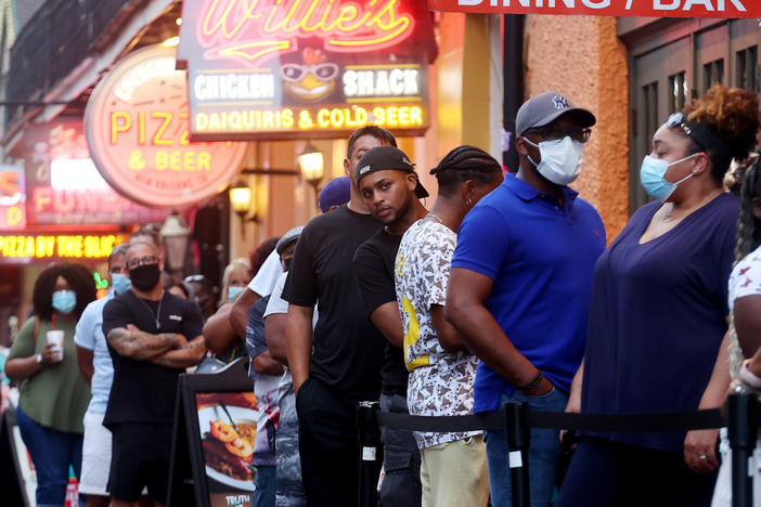 People queue to enter a restaurant in New Orleans' French Quarter in early August.