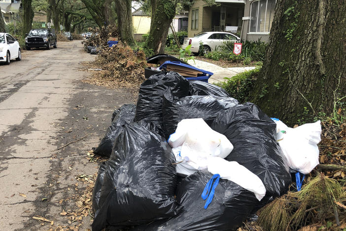 Bags of garbage pile up on a New Orleans street on Friday. Trash collection delays have left some residents outraged at the city's contractors.