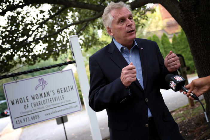 Former Virginia Gov. Terry McAuliffe, a Democrat running for a second term, answers questions from the media after touring Whole Woman's Health of Charlottesville on Sept. 9. He's working to rally voters in response to Texas' restrictive new abortion law.