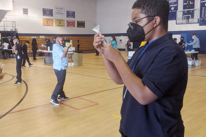 Julian Hernandez (right), 12, a seventh-grader at Hillside School in Illinois, says he feels much safer being back in school knowing that a weekly testing program is identifying those who are sick with COVID-19.