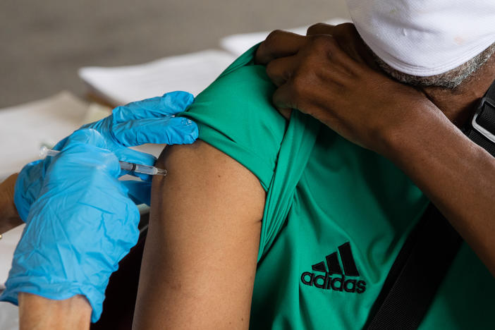 Rufus Peoples receives a dose of the Pfizer-BioNTech COVID-19 vaccine at a vaccination clinic in Southfield, Mich., in August.