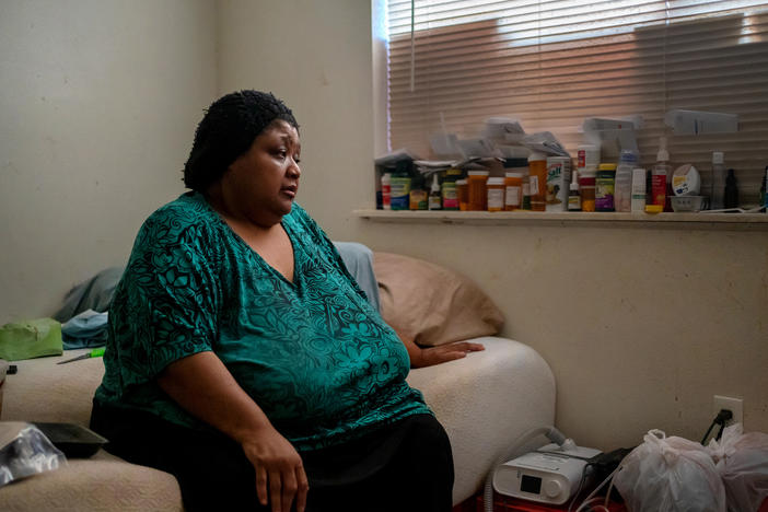 Wilma Banks, who lives in the neighborhood of New Orleans East, sits on her bed next to her nebulizer and CPAP machine. In the aftermath of Hurricane Ida, when much of New Orleans was left without power, she wasn't able to power up the medical devices and had only her limited supply of inhalers to widen her airways.