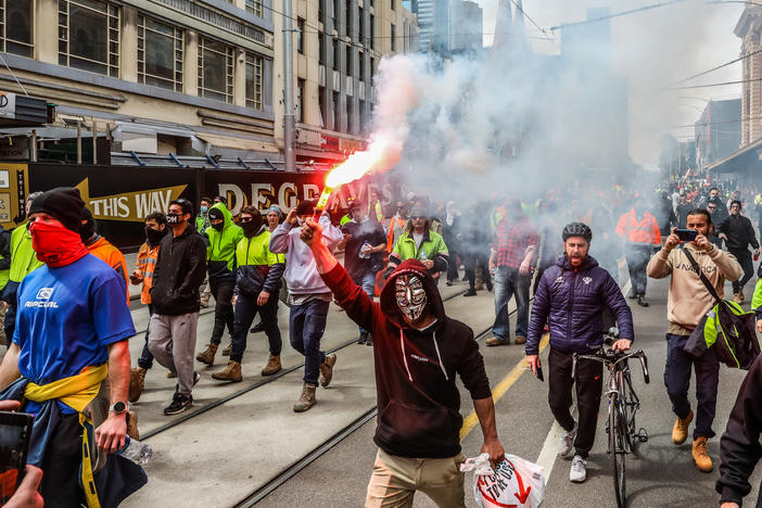 Protesters march through Melbourne, Australia, on Tuesday over recently announced COVID-19 vaccine requirements for construction workers. Construction sites have been shut down for two weeks due to protests and rising COVID-19 cases.