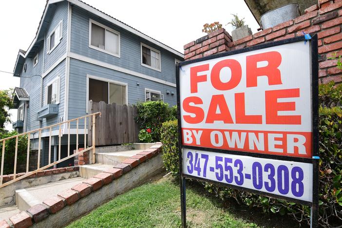 A "For Sale by Owner" sign is posted in front of property in Monterey Park, Calif., in April 2020.