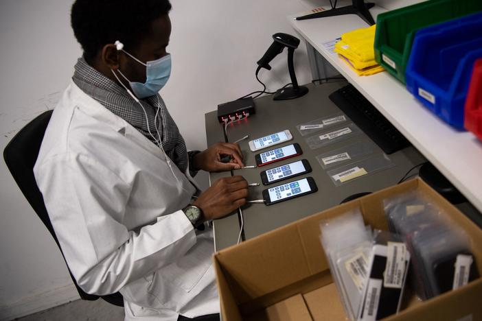 An employee works on smartphones reconditioning in France in January.