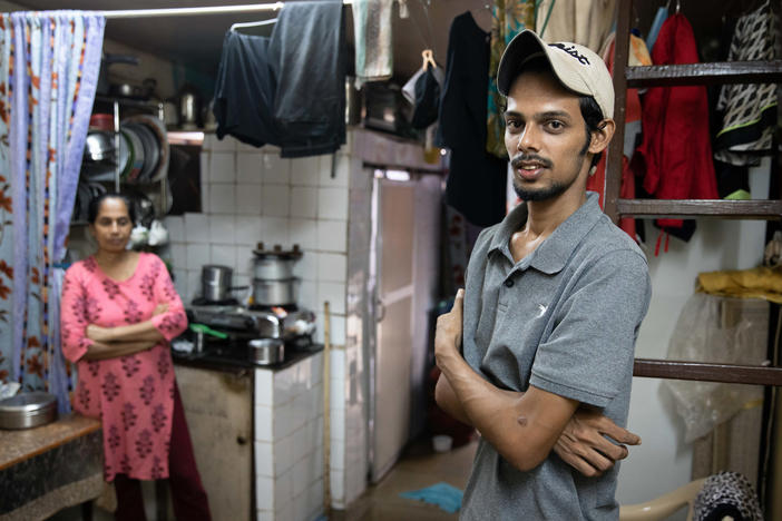 Salman Khan Rashid, 24, right, and his mother, Sana Rashid, at home. Salman lost his job as a golf coach at a Mumbai sports club during the pandemic. The household, which includes Salman's three sisters, is now surviving on savings. But when he's able, he'll give a little money or food to others facing food insecurity.