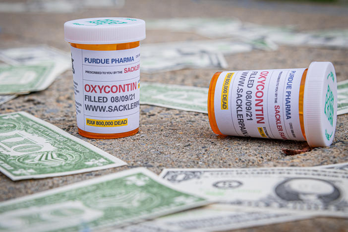 Demonstrators scatter fake money and prescription bottles of OxyContin in August outside of U.S. Bankruptcy Court in White Plains, where the Purdue bankruptcy hearings were held.