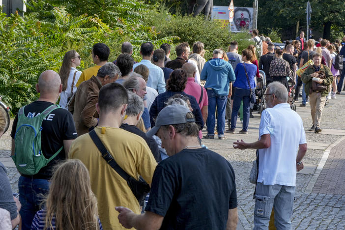 People queue in front of a polling station in the Moabit district of Berlin, Germany. German voters are choosing a new parliament in an election that will determine who succeeds Chancellor Angela Merkel after her 16 years at the helm of Europe's biggest economy.